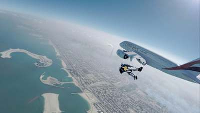 Jetmen Yves Rossy and Vince Reffet fly next to an Airbus 