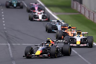 A line of cars follow close behind Max Verstappen at Albert Park Circuit in Melbourne, 2026