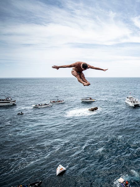 Blake Aldridge of the UK dives from the 27m platform during the fourth stop of the Red Bull Cliff Diving World Series in Sao Miguel, Azores, Portugal on June 22, 2019.