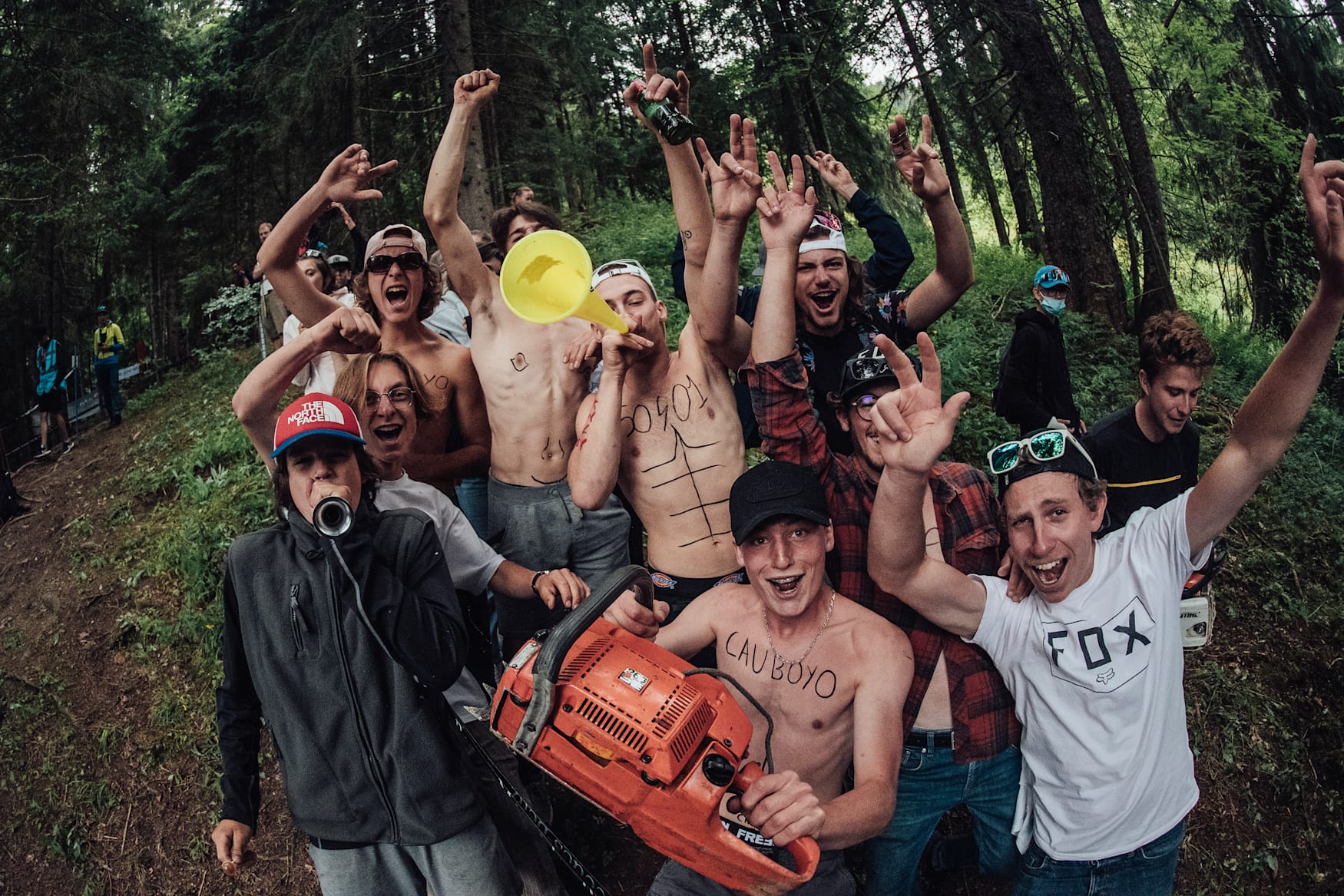 Fans with noise makers and chainsaws stand by the track in Les Gets 2021.