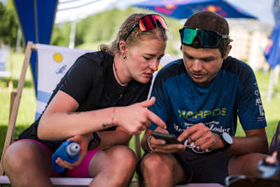 Celine Lorenz reviews race data and plans the next move during Red Bull X-Alps in Sankt Moritz, Switzerland, June 2025, embodying the adventurous spirit of Red Bull's legendary event