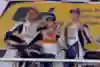 Dani Pedrosa is in the middle of the podium after winning the 2008 Spanish Grand Prix with Valentino Rossi on the left and Jorge Lorenz on the right of the picture.