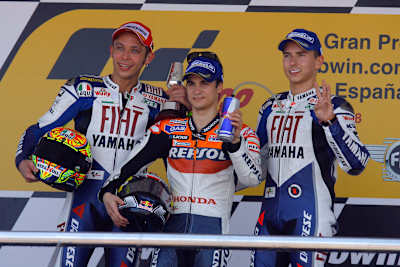 Dani Pedrosa is in the middle of the podium after winning the 2008 Spanish Grand Prix with Valentino Rossi on the left and Jorge Lorenz on the right of the picture.