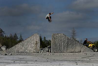 Angelo Caro bones out his tail on a frontside grab over a granite gap box in Norway.