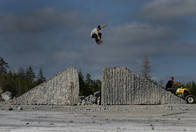 Angelo Caro bones out his tail on a frontside grab over a granite gap box in Norway.