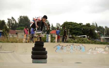 Ethiopian ripper Henok Yetbarek ollies stacked tyres at Awassa skatepark