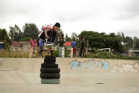 Ethiopian ripper Henok Yetbarek ollies stacked tyres at Awassa skatepark