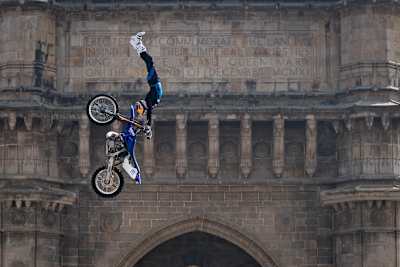 Tom Pagès doing a stunt on his motorbike in Mumbai.