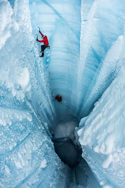 Will Gadd and a team member climbing vertically out a moulin during Gadd's trip to explore the Greenland ice cap in 2018.