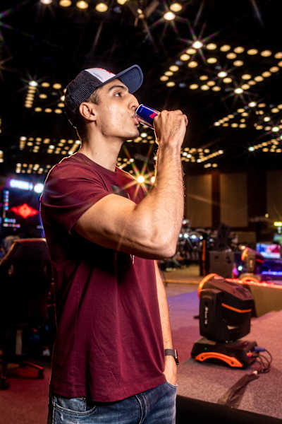Indian gamer Ankit 'V3nom' Panth drinks a can of Red Bull at an event.