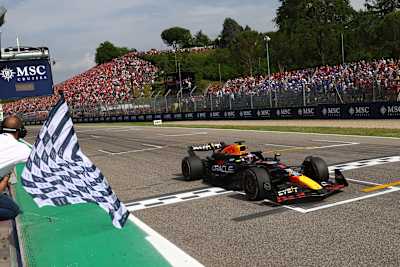 Race winner Max Verstappen takes the chequered flag during the F1 Grand Prix of Emilia-Romagna at Autodromo Enzo e Dino Ferrari Circuit on May 19, 2024 in Imola, Italy.