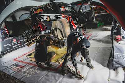 W warsztacie Toyota Gazoo Racing 2024 mechanicy serwisują samochód rajdowy