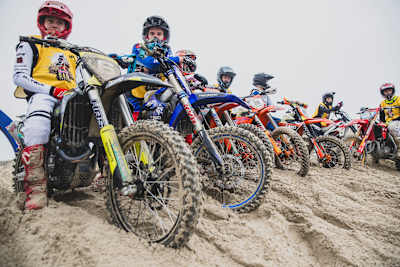 In 2024, motocross riders compete at the Red Bull Sand Session event during the Enduropale in France, navigating sandy terrain on powerful dirt bikes.