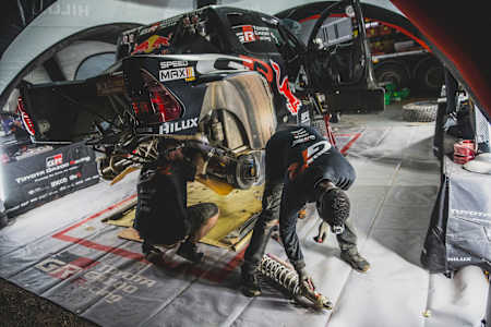In the 2024 Toyota Gazoo Racing workshop, mechanics service a rally car