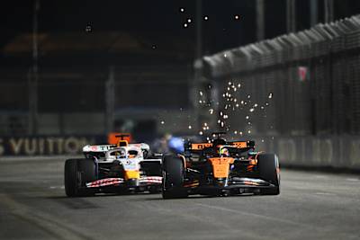 Oscar Piastri leads Isack Hadjar during the F1 Grand Prix of Singapore at Marina Bay Street Circuit on October 05, 2025 in Singapore.