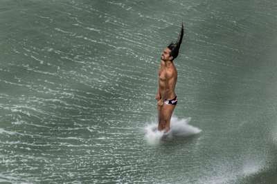 Orlando Duque enters the water during Red Bull Cliff Diving.