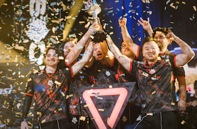 G2 Esports lift the Red Bull Home Ground World Finals trophy amid falling confetti after winning the 2025 championship in New York City.