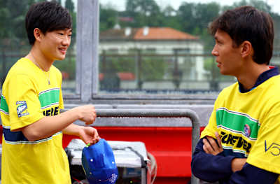 Yuki Tsunoda and Alexander Albon talk at the tribute to Ayrton Senna and Roland Ratzenberger during previews ahead of the F1 Grand Prix on May 16, 2024 in Imola, Italy. 