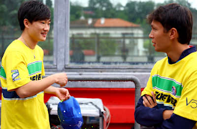 Yuki Tsunoda and Alexander Albon talk at the tribute to Ayrton Senna and Roland Ratzenberger during previews ahead of the F1 Grand Prix on May 16, 2024 in Imola, Italy. 