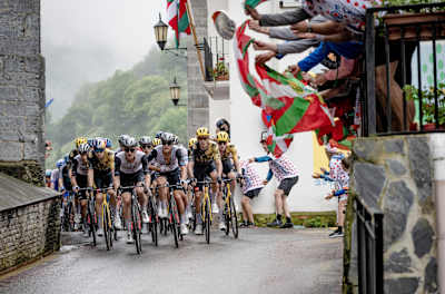 Fans wave Basque flags during the Tour de France 2023 in Vizkaya.