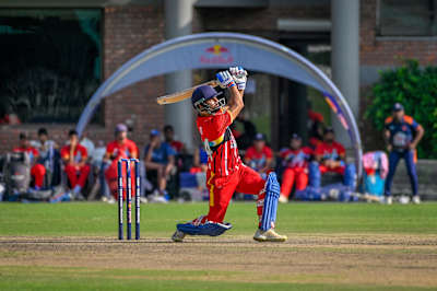 A dynamic moment from the Red Bull Campus Cricket 2023 League Match at Abhimanyu Cricket Academy Stadium in Dehradun, India, as a batsman unleashes a powerful shot