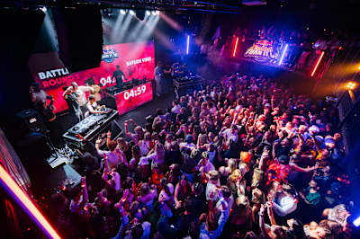 A massive crowd pulses with energy as DJs battle on stage at Red Bull Turn It Up in Helsingborg, 2025, under vibrant lights and big beats for an unforgettable club showdown.
