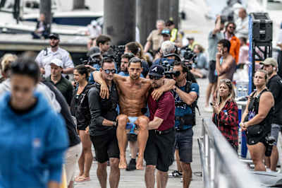 In 2024, Constantin Popovici is carried after an injury at the Red Bull Cliff Diving World Series event in Boston