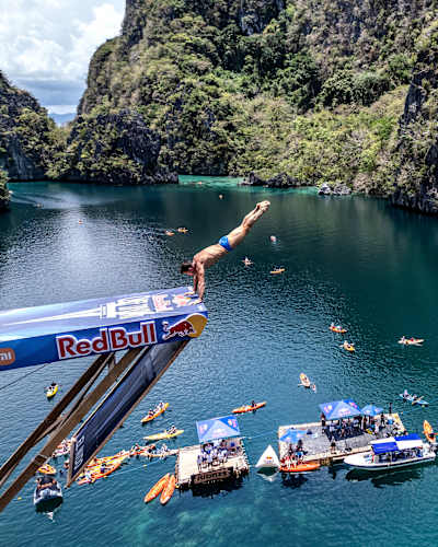 Romanian diver Constantin Popovici drops into the Big Lagoon from 27 metres on Day 3