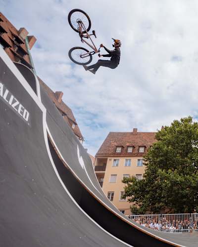 Emil Johansson performs a breathtaking Alley-Oop Tailwhip at Red Bull District Ride 2022 in Nuremberg, Germany.