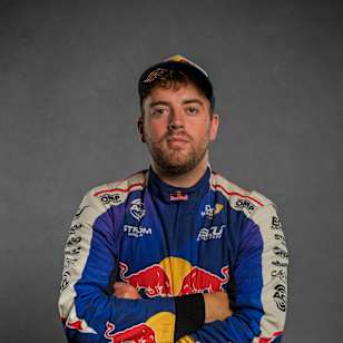 Red Bull athlete Conor Shanahan stands confidently in his racing suit at Drift Masters European Championship Madrid 2025, ready to take on high-speed drifting challenges.