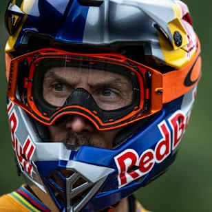 In 2025, Gee Atherton wears a Red Bull helmet and goggles at Red Bull Hardline in Dinas Mawddwy, Wales.