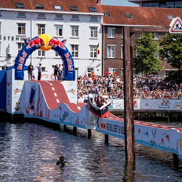 Participants showcase their wild creations during Red Bull Vél'Eau 2026 in Hasselt, Belgium, launching imaginative vehicles from a ramp into the water as crowds cheer them on