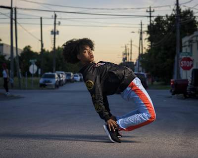 Angyil grab her heels while bending backwards.
