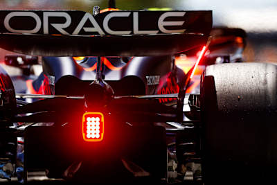 At the rear of a Formula One car, a flashing light indicates that the battery is being charged during the race.