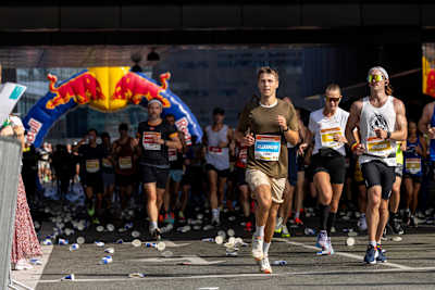 Runners race past Red Bull arch during Copenhagen Half Marathon.