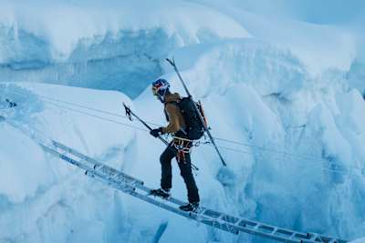 In 2022, Andrzej Bargiel crosses a ladder bridge during the Everest Ski Challenge.