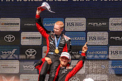 Kalle Rovanperä and Sébastien Ogier (FRA) celebrate on the podium at Rally Finland in Jyvasküla, Finland.