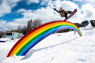In April 2022, Seb Toots rides a rainbow rail at the Red Bull Obstacle Course event in Saint-Donat, Canada.