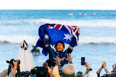 Jack Robinson of Australia celebrates his spectacular win at the Rip Curl Pro Bells Beach 2025, surrounded by an electrified crowd at the iconic Bells Beach, Victoria