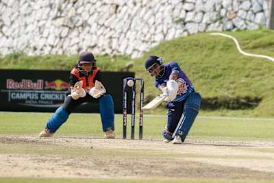Dynamic cricket moment during the 2023 Red Bull Campus Cricket Women’s Final at Abhimanyu Cricket Academy Stadium, Dehradun, showcasing intense sporting spirit