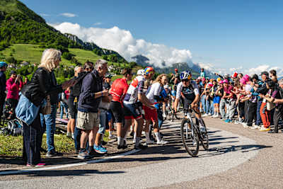 Red Bull athlete Tom Pidcock rides with intensity during the Giro d'Italia 2025 in San Valentino, Italy, cheered on by enthusiastic fans on a stunning mountain stage