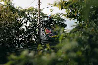 Tomáš Slavík launches into action at Red Bull Cerro Abajo in Genova, Italy, August 2025, showcasing fearless downhill biking and Red Bull's iconic branding