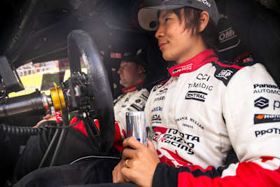 Takamoto Katsuta and Aaron Johnston of TOYOTA GAZOO RACING WRT prepare for Stop 6 of the FIA World Rally Championship in Porto, Portugal, with Red Bull energy in hand, May 2026