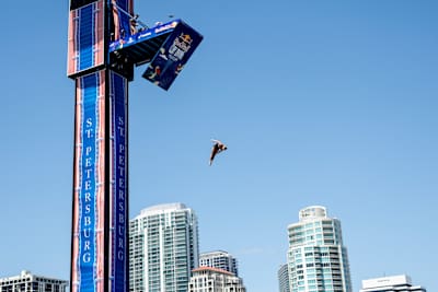 Australian diver Rhiannan Iffland launches from the 21 metre platform at Red Bull Cliff Diving World Series 2026 in St. Petersburg, USA, soaring high against the city skyline