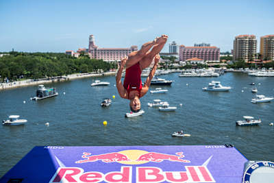Simone Leathead of Canada performs a daring dive from the 21 metre platform during the 2026 Red Bull Cliff Diving World Series second stop in St. Petersburg, USA, with boats lining the waterfront