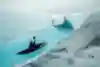 Aniol Serrasolses paddles the river on the Austfonna ice cap, Svalbard, Norway, on August 7, 2023