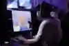 A gamer wearing a Red Bull cap focuses intently on the screen during the Red Bull Home Ground event in Istanbul, Turkey.