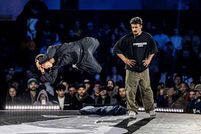 X-Rain (left) of China competes against Mighty Jake of Venezuela during the Red Bull BC One World Final at Court Philippe-Chatrier, Roland Garros, Paris, France, on October 21, 2023.