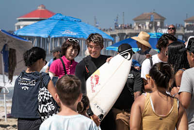 Kanoa Igarashi takes photos with fans at the Vans US Open of Surfing in Huntington Beach on August 2, 2022. 