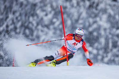 Switzerland's Daniel Yule knocks a slalom pole away with his hand.